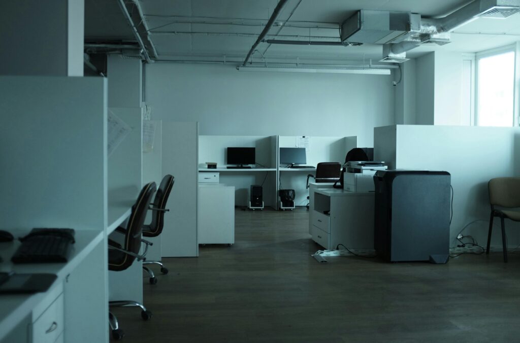 An empty modern office space in Kyiv featuring workstations, chairs, and technology.